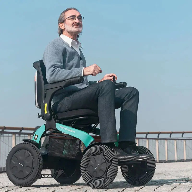 Man using Robooter E60 Pro All Terrain Electric Folding Powerchair on a clear day