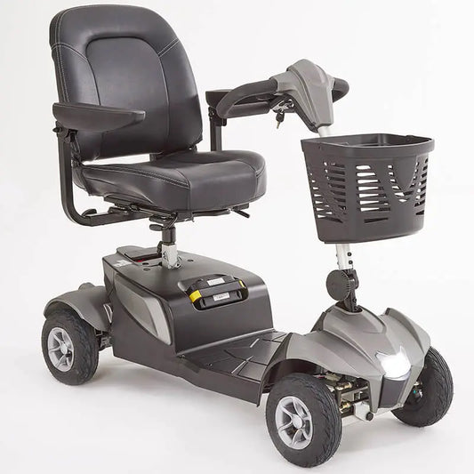 The Motion Healthcare Aura builds on the Airium's success, offering a lightweight aluminium frame (15.5kg) and a 2.6kg lithium battery with a 21-mile range. Features include pneumatic tyres, front/rear suspension, an adjustable swivelling captain's seat with flip-up armrests, and a digital LCD control panel with a front light, indicators, and adjustable delta tiller. It disassembles into six parts for easy transport, making it ideal for various terrains and travel._img