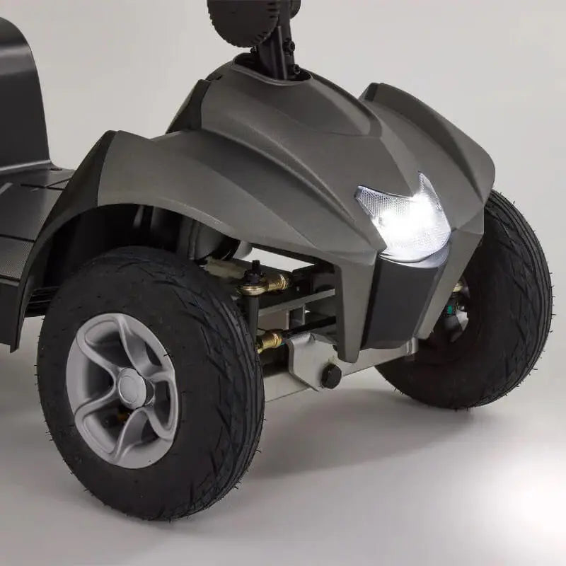 The Motion Healthcare Aura builds on the Airium's success, offering a lightweight aluminium frame (15.5kg) and a 2.6kg lithium battery with a 21-mile range. Features include pneumatic tyres, front/rear suspension, an adjustable swivelling captain's seat with flip-up armrests, and a digital LCD control panel with a front light, indicators, and adjustable delta tiller. It disassembles into six parts for easy transport, making it ideal for various terrains and travel.