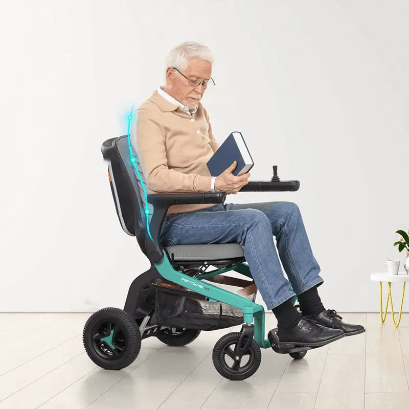 old guy holding a book riding in Robooter E40 Indoor Folding Powerchair classic green