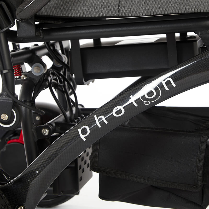 Experience next-level mobility with the Photon Folding Electric Powerchair. Weighing just 17kg without the battery and crafted from carbon fibre, it offers a 12-mile range on a single charge. Designed for users up to 23.5 stone, it combines comfort, support, and a sleek, minimalist design. Navigate busy streets or rough terrain with ease, enjoying unmatched performance and reliability. The Photon redefines lightweight, robust mobility.
