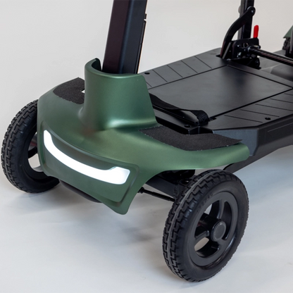 Close-up of a green Smarti Plus Lightweight Auto-Folding Mobility Scooter with reflective strip on a white background