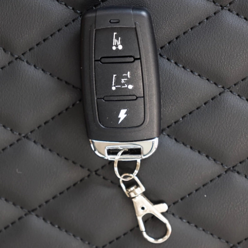 Smarti Plus Lightweight Auto-Folding Mobility Scooter key fob with remote controls on a textured black surface