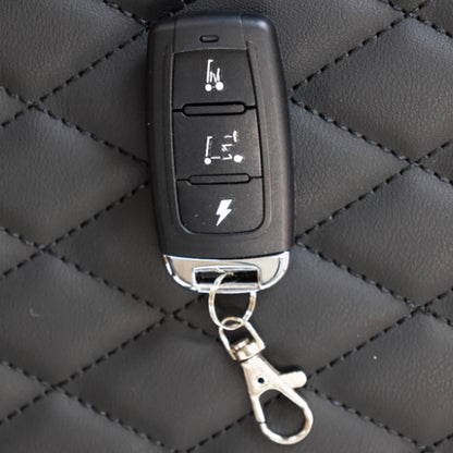 Smarti Plus Lightweight Auto-Folding Mobility Scooter key fob with remote controls on a textured black surface