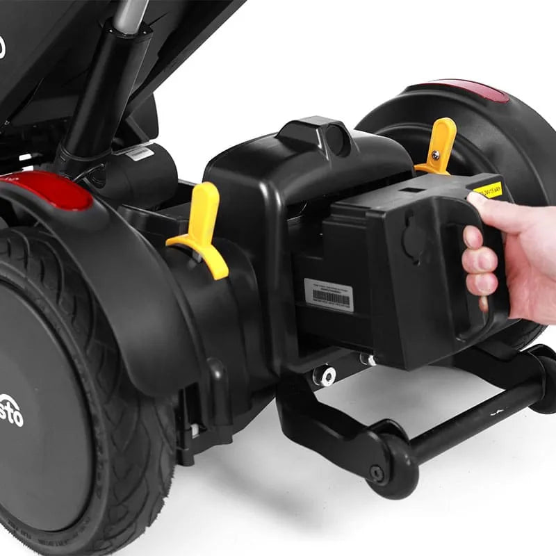 Close-up of XSTO M4 Pro Smart Self Balancing Powered Wheelchairwith a hand holding the battery
, on a white background.