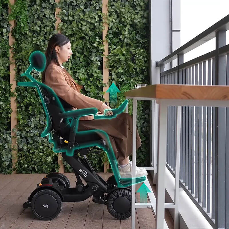 Person using XSTO M4 Pro Smart Self Balancing Powered Wheelchair on a wooden floor with plants in the background