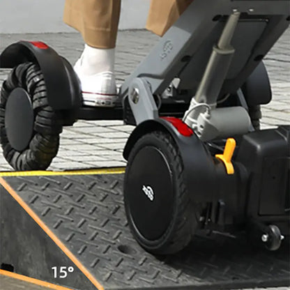 Close-up of a XSTO M4 Electric Powered Wheelchair on a ramp with a person's foot wearing a white shoe.