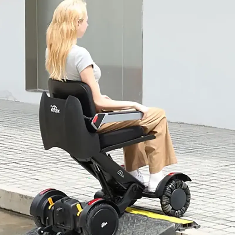 Person using a Mobility World Ltd UK: XSTO M4 Electric Powered Wheelchair on a sidewalk