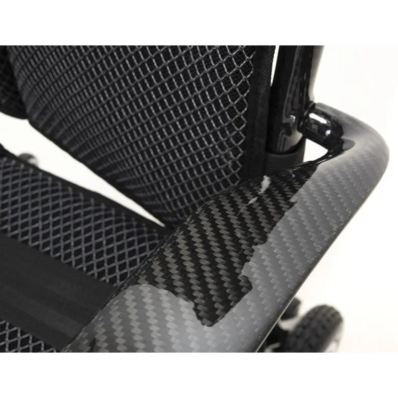 Close-up of a black mesh seat with a textured pattern of AeroCarbon Carbon Fibre Folding Powerchair Wheelchair on a white background