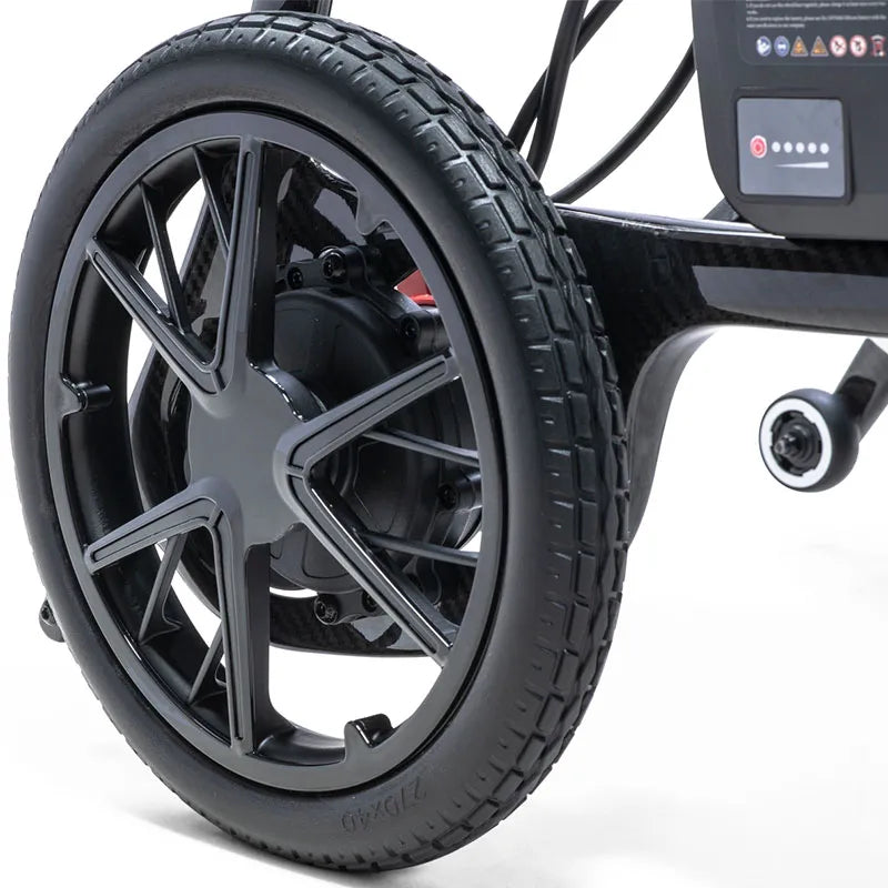 Close-up of a black AeroCarbon Carbon Fibre Folding Powerchair Wheelchair wheel on a white background