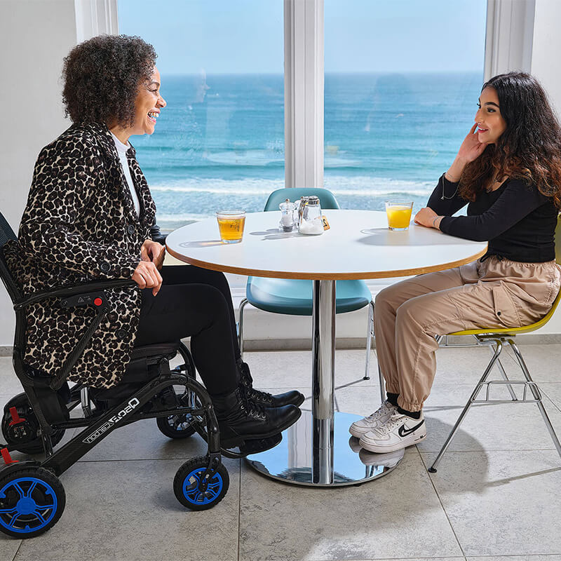 mobility_world_ltd_uk_quickie_q50_r_carbon_folding_powerchair_lifestyle