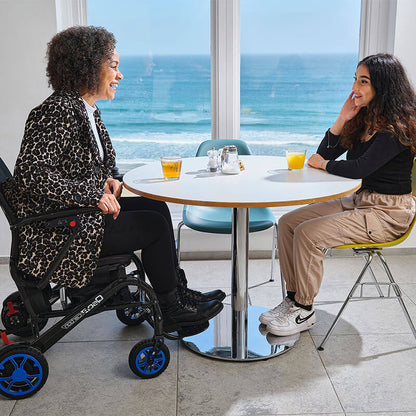 mobility_world_ltd_uk_quickie_q50_r_carbon_folding_powerchair_lifestyle