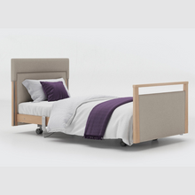 Load image into Gallery viewer, The Opera® Signature Upholstered is height adjustable for nursing and access. The bed has an extensive height range that allows it to be lowered close to the floor and raised to a carer&#39;s waist level.