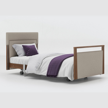 Load image into Gallery viewer, The Opera® Signature Upholstered is height adjustable for nursing and access. The bed has an extensive height range that allows it to be lowered close to the floor and raised to a carer&#39;s waist level.