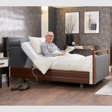 Load image into Gallery viewer, The Opera® Signature Upholstered is height adjustable for nursing and access. The bed has an extensive height range that allows it to be lowered close to the floor and raised to a carer&#39;s waist level.