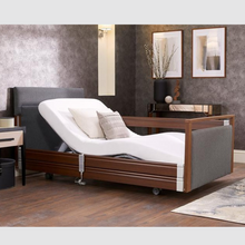 Load image into Gallery viewer, The Opera® Signature Upholstered is height adjustable for nursing and access. The bed has an extensive height range that allows it to be lowered close to the floor and raised to a carer&#39;s waist level.