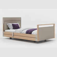 Load image into Gallery viewer, Opera Signature Upholstered Profiling Bed With Cot Sides. The padded head and footboard design ensure&#39;s a comfortable and elegant finish. With height adjustment and full profiling features, this care bed is suitable for almost all user types.
