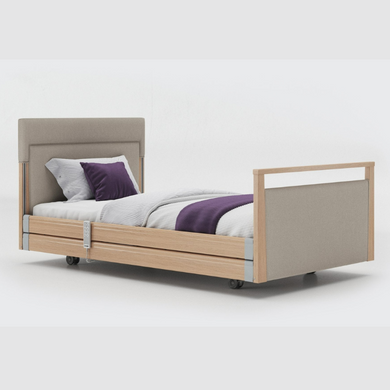 Opera Signature Upholstered Profiling Bed With Cot Sides. The padded head and footboard design ensure's a comfortable and elegant finish. With height adjustment and full profiling features, this care bed is suitable for almost all user types.