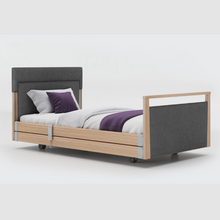 Load image into Gallery viewer, Opera Signature Upholstered Profiling Bed With Cot Sides. The padded head and footboard design ensure&#39;s a comfortable and elegant finish. With height adjustment and full profiling features, this care bed is suitable for almost all user types.