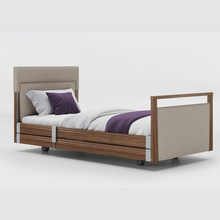 Load image into Gallery viewer, Opera Signature Upholstered Profiling Bed With Cot Sides. The padded head and footboard design ensure&#39;s a comfortable and elegant finish. With height adjustment and full profiling features, this care bed is suitable for almost all user types.