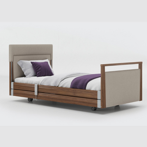 Opera Signature Upholstered Profiling Bed With Cot Sides. The padded head and footboard design ensure's a comfortable and elegant finish. With height adjustment and full profiling features, this care bed is suitable for almost all user types.