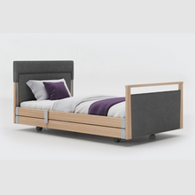 Load image into Gallery viewer, Opera Signature Upholstered Profiling Bed With Cot Sides. The padded head and footboard design ensure&#39;s a comfortable and elegant finish. With height adjustment and full profiling features, this care bed is suitable for almost all user types.