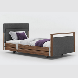 Opera Signature Upholstered Profiling Bed With Cot Sides. The padded head and footboard design ensure's a comfortable and elegant finish. With height adjustment and full profiling features, this care bed is suitable for almost all user types.