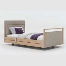 Load image into Gallery viewer, Opera Signature Upholstered Profiling Bed With Cot Sides. The padded head and footboard design ensure&#39;s a comfortable and elegant finish. With height adjustment and full profiling features, this care bed is suitable for almost all user types.