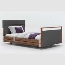 Load image into Gallery viewer, Opera Signature Upholstered Profiling Bed With Cot Sides. The padded head and footboard design ensure&#39;s a comfortable and elegant finish. With height adjustment and full profiling features, this care bed is suitable for almost all user types.