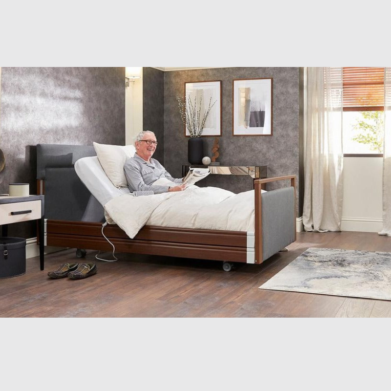 Opera Signature Upholstered Profiling Bed With Cot Sides & Memory Mattress. The padded head and footboard design ensure's a comfortable and elegant finish. With height adjustment and full profiling features, this care bed is suitable for almost all user types.