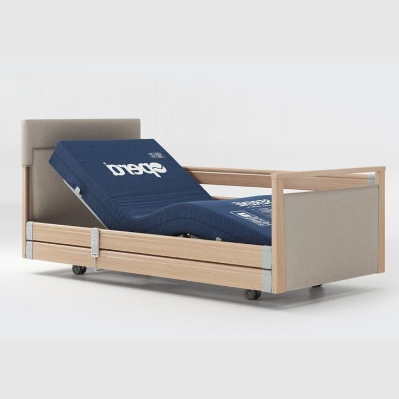 Opera Signature Upholstered Profiling Bed With Cot Sides & Memory Mattress. The padded head and footboard design ensure's a comfortable and elegant finish. With height adjustment and full profiling features, this care bed is suitable for almost all user types.