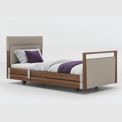 Opera Signature Upholstered Profiling Bed With Cot Sides & Memory Mattress. The padded head and footboard design ensure's a comfortable and elegant finish. With height adjustment and full profiling features, this care bed is suitable for almost all user types.