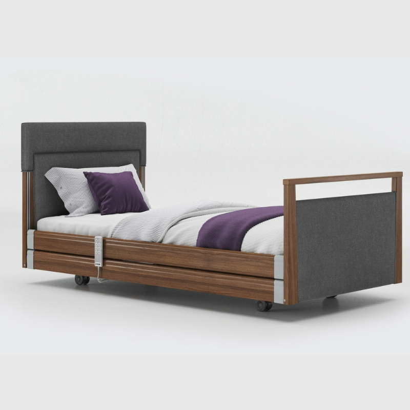 Opera Signature Upholstered Profiling Bed With Cot Sides & Memory Mattress. The padded head and footboard design ensure's a comfortable and elegant finish. With height adjustment and full profiling features, this care bed is suitable for almost all user types.
